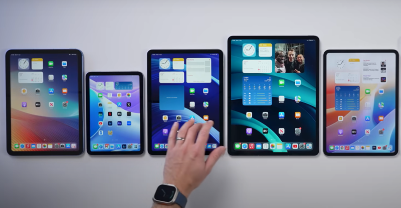 5 different ipads being placed on the table