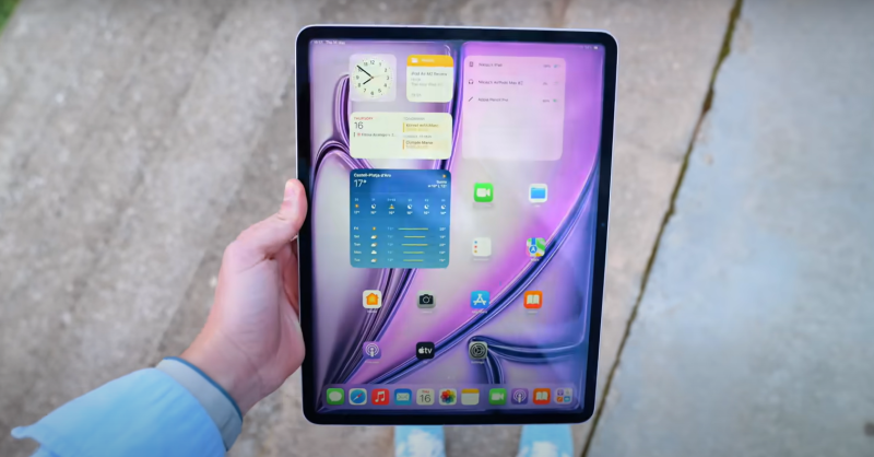 a hand holding an ipad